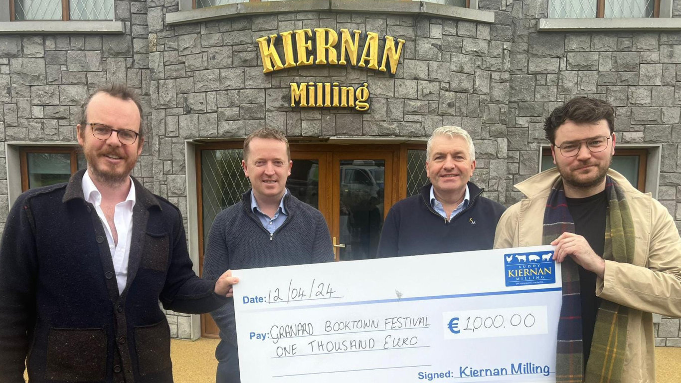 image of john connell, ronan o toole, holding a large check for 1000 euro with mark kiernan and chris